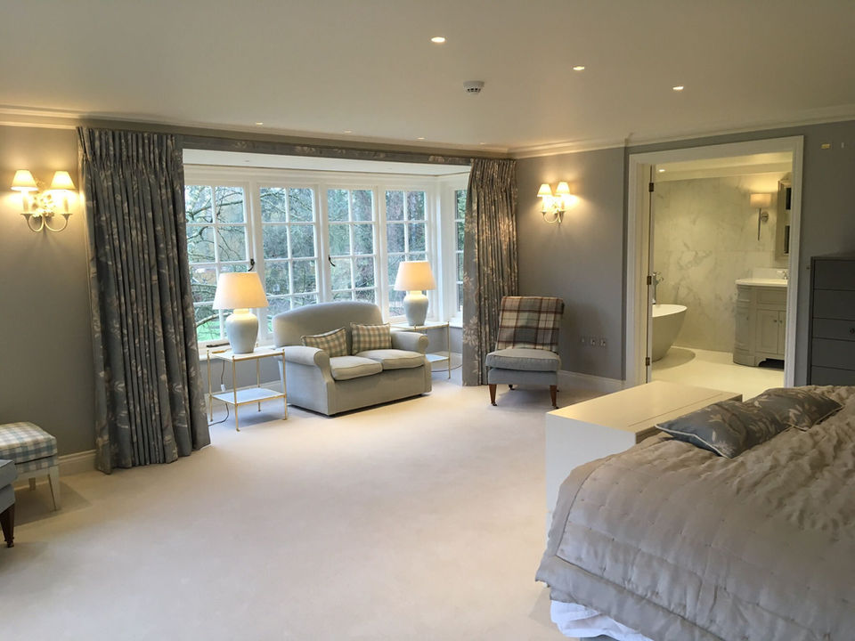 Luxury bedroom with fitted wardrobes and soft lighting