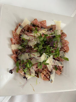 Carpaccio with parmesan, arugula, and balsamic