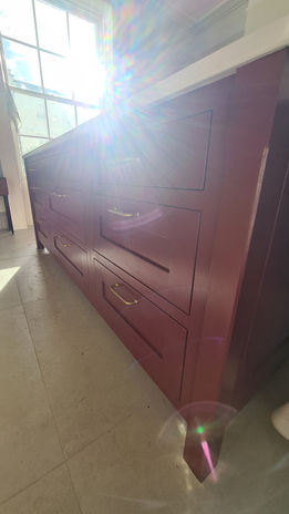 Gloss red kitchen unit with chrome handles.