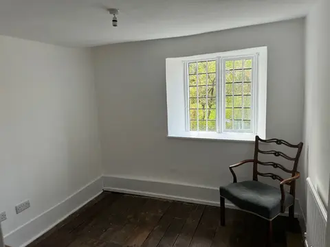 A large window with a chair beside it