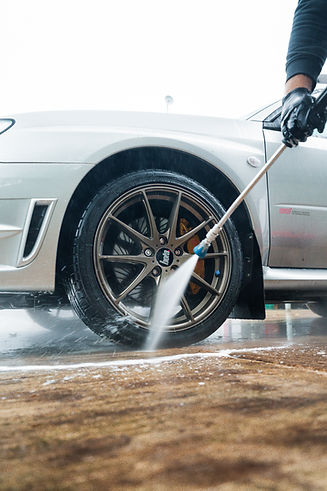 car wheel being pressure washed