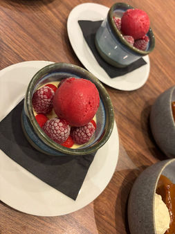 Individual desserts with berry sorbet and raspberries