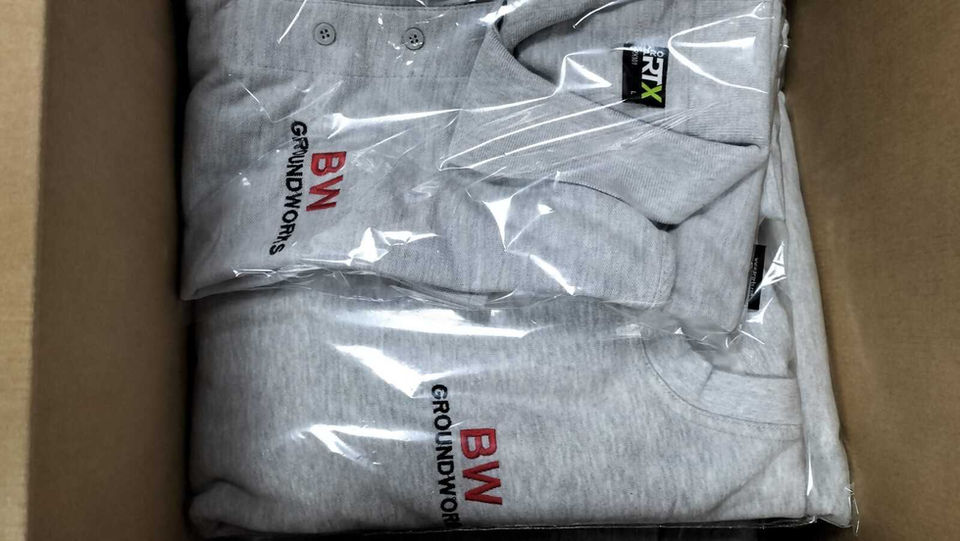 Grey embroidered workwear folded in box