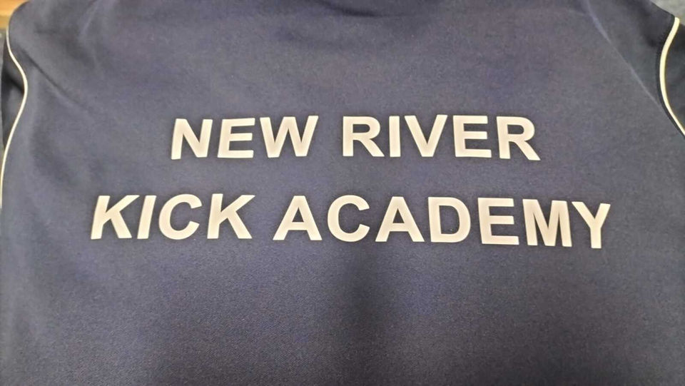 Dark top with "New River Kick Academy" gold text