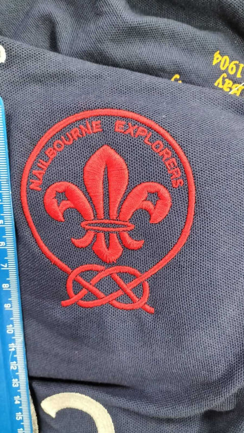 Navy garment with red Scouts fleur-de-lis embroidery