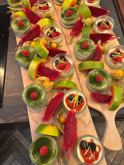 Assortment of mini desserts with fruit on wooden serving boards