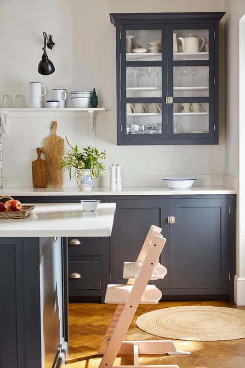 Kitchen with dark cabinets and high chair