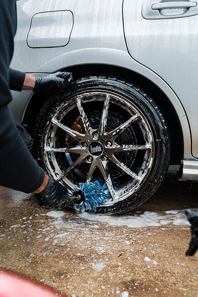 close up of an alloy wheel being cleaned