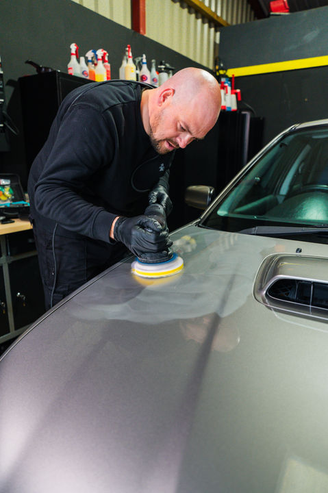 man polishing a car