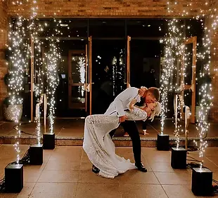 Indoor cold spark machine fountain backdrop illuminating a couple's wedding dance floor weddings glasgow