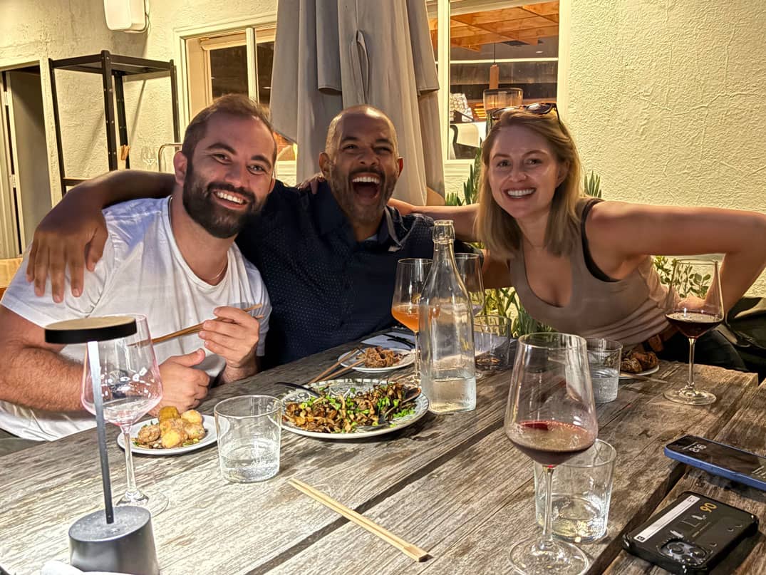 Three peers at a dinner table