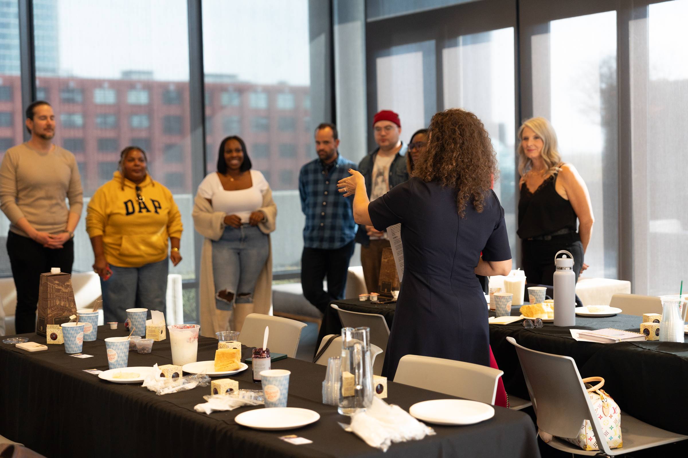 A group of professionals partaking in an icebreaker activity during a networking event