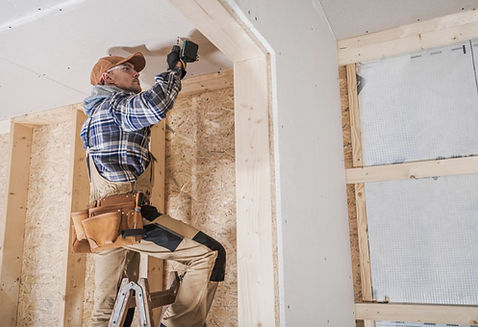 Contractors removing cabinets during kitchen demolition in Leduc