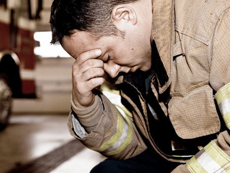 Firefighter with head in hand