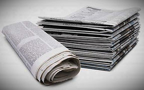 stack-of-newspapers-with-one-rolled_edit