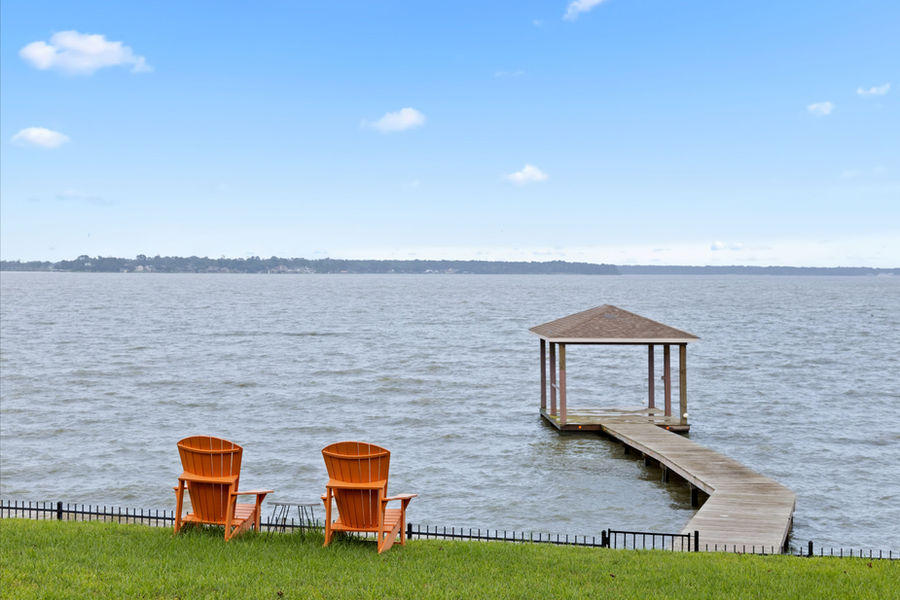 Waterfront backyard with private dock and lake views: luxury home photography, Houston by Marz Media Photography