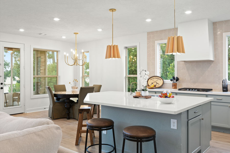 Open kitchen with breakfast bar and recessed lighting: luxury real estate photography in Houston, TX by Marz Media Photography