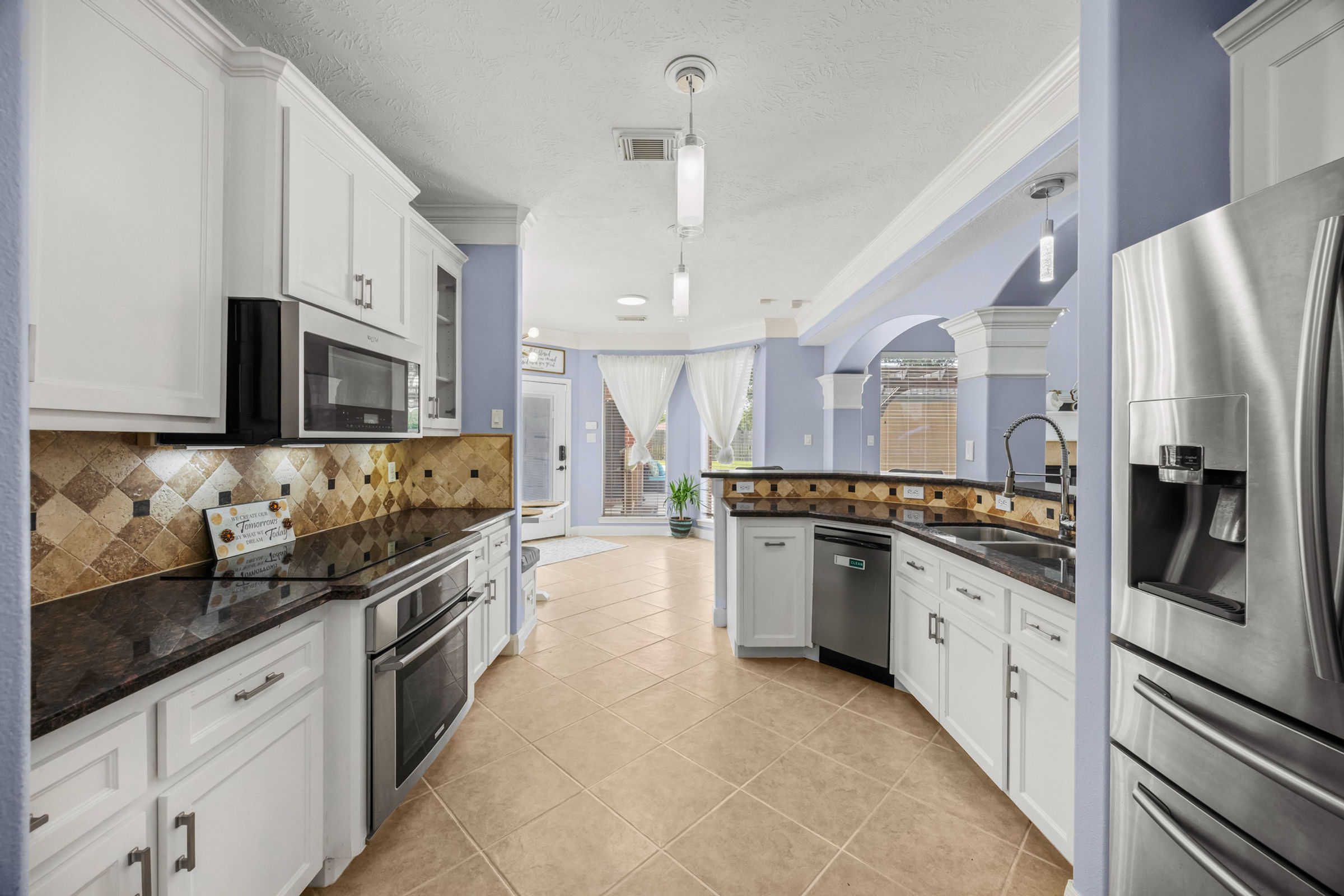 Luxury kitchen with island and custom cabinetry: luxury real estate photography in Houston, TX by Marz Media Photography