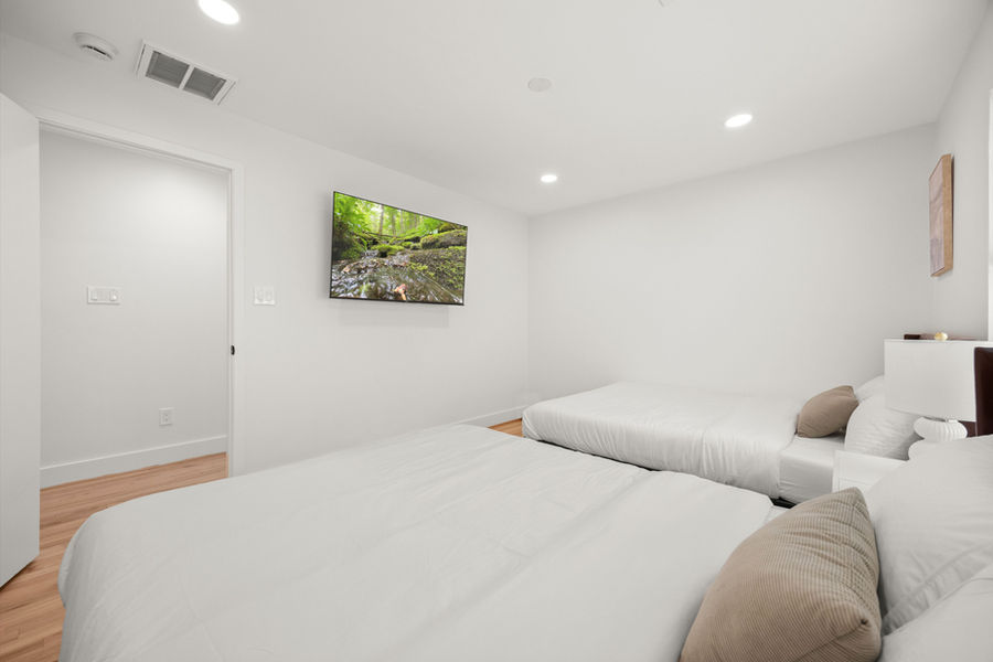 Bedroom with hardwood floors: Houston real estate photography by Marz Media Photography