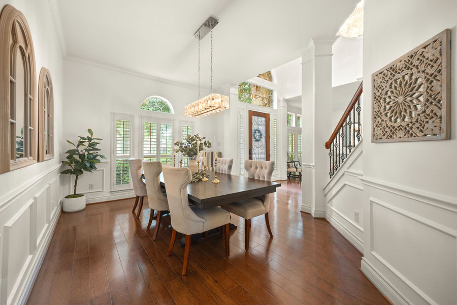 Dining room with wainscoting and hardwood floors: luxury real estate photography in Houston, TX by Marz Media Photography