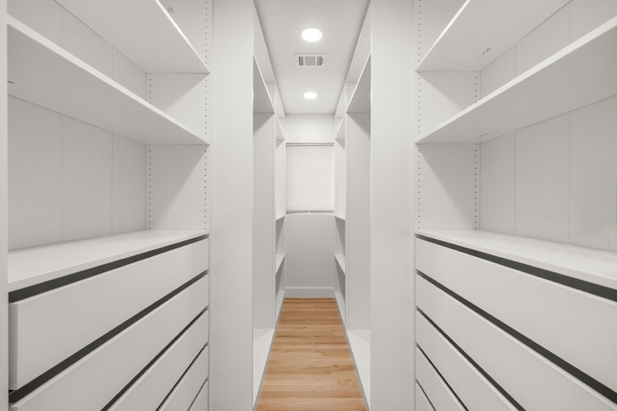 Walk-in closet with custom shelving: luxury real estate photography in Houston, TX by Marz Media Photography
