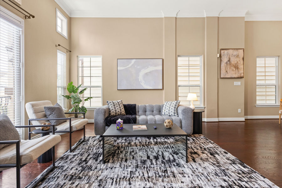 Styled living room with window treatments: HDR real estate photography for a Houston listing by Marz Media Photography