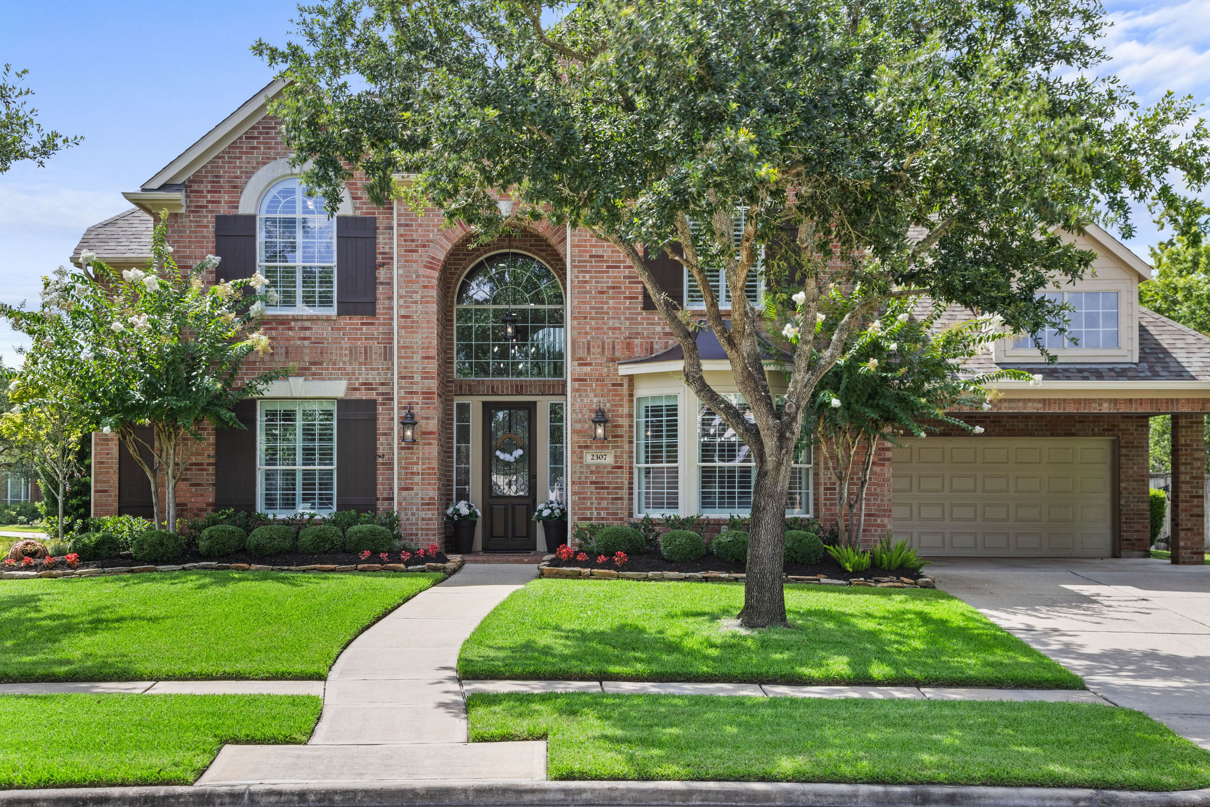Front elevation with landscaped yard: luxury real estate photography in Houston, TX by Marz Media Photography