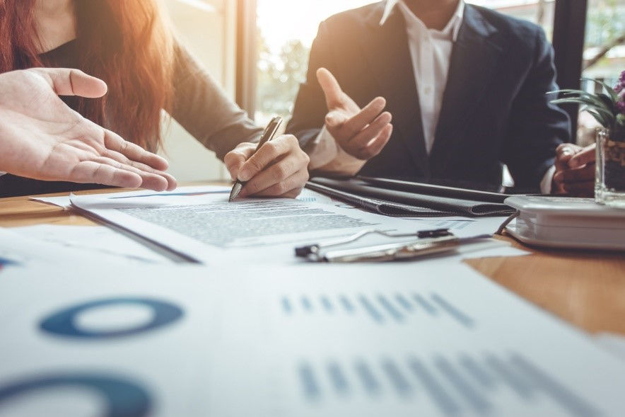 Business people collaborating on planning the sale of a business