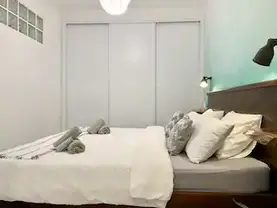 large wardrobe and bed.webp