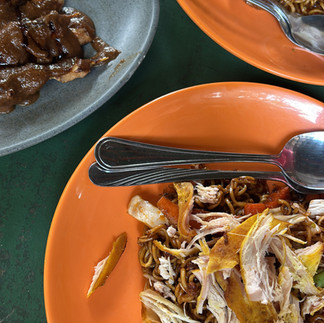 Traditional Indonesian fried noodles with shredded chicken served at a local restaurant in Lombok.