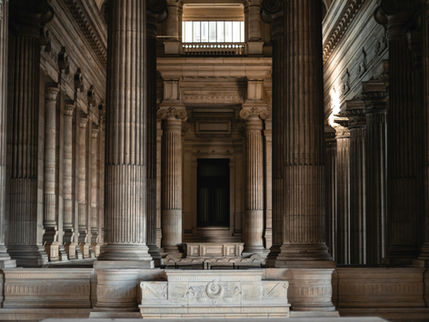 Classical courthouse interior with towering stone columns, representing the institutional legal architecture that Indonesia's proposed IIFC dedicated court aims to establish for international dispute resolution.