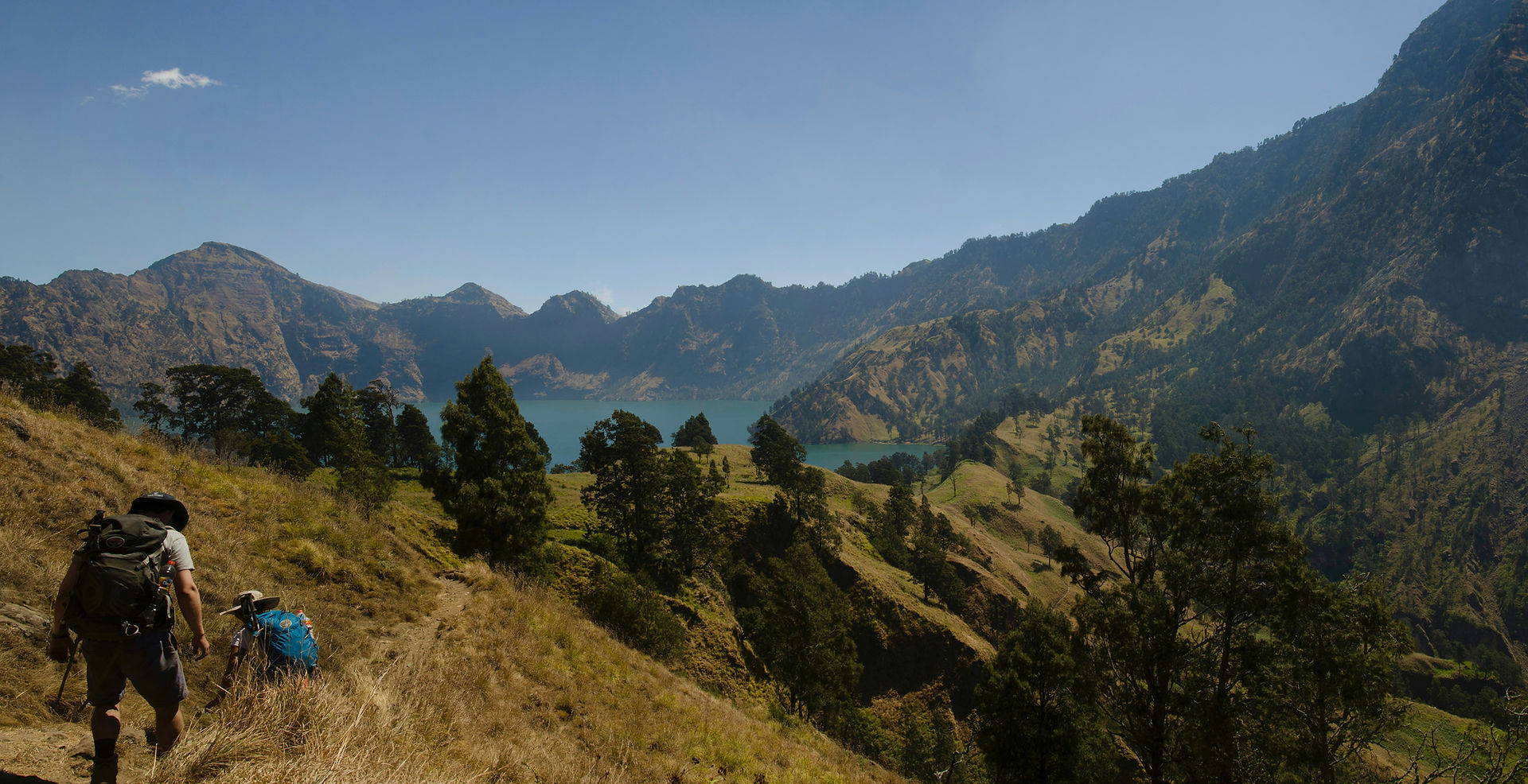 Panoramic view of green valleys from a hiking viewpoint above Tetebatu