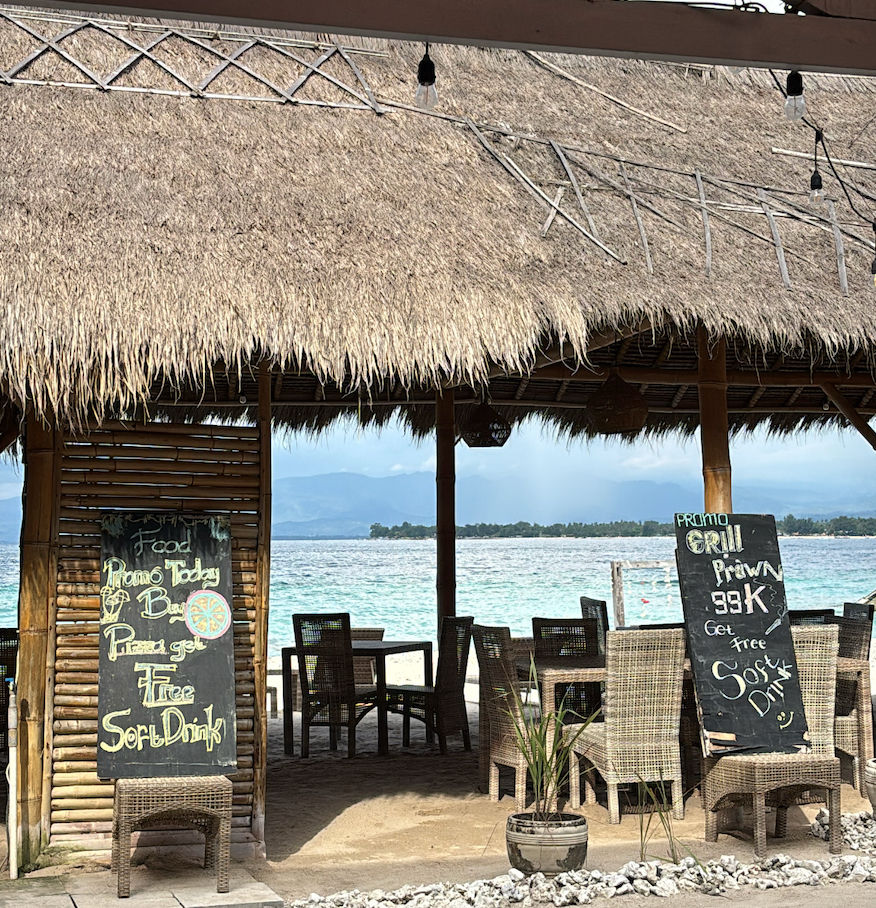 Beachfront cafe on the Gili Islands with a thatched roof overlooking the water
