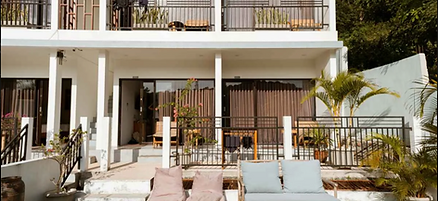 White modern building at DHM Surf Camp with balconies in Kuta, Lombok