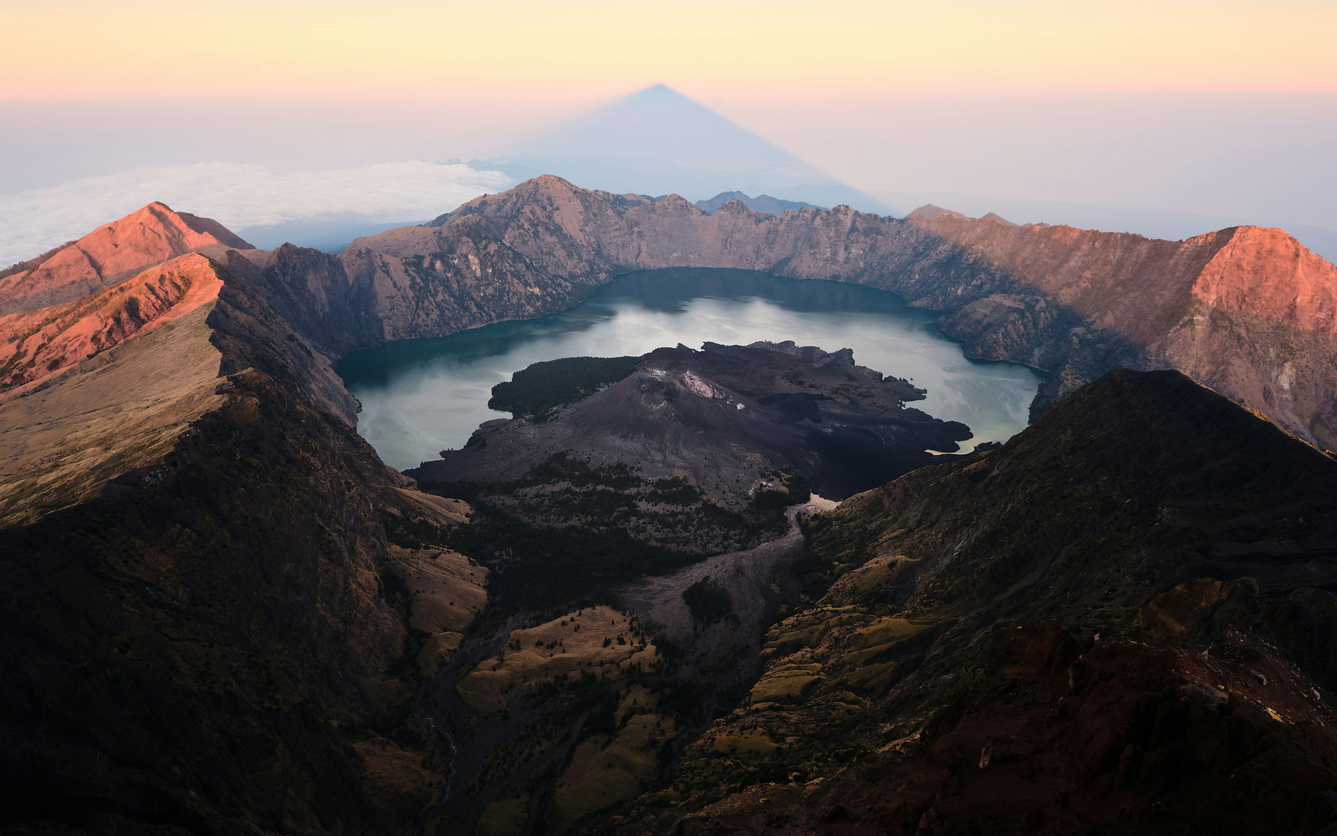 View of Segara Anak crater lake from the summit of Mount Rinjani at sunrise, Lombok, Indonesia.