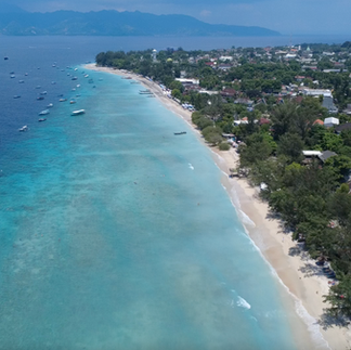 Colorful surfboards lined up on the beach at Gili Trawangan, reflecting the island's laid-back surf culture.