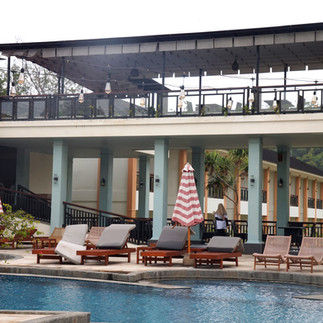 Beachfront resort pool with sun loungers on the Gili Islands
