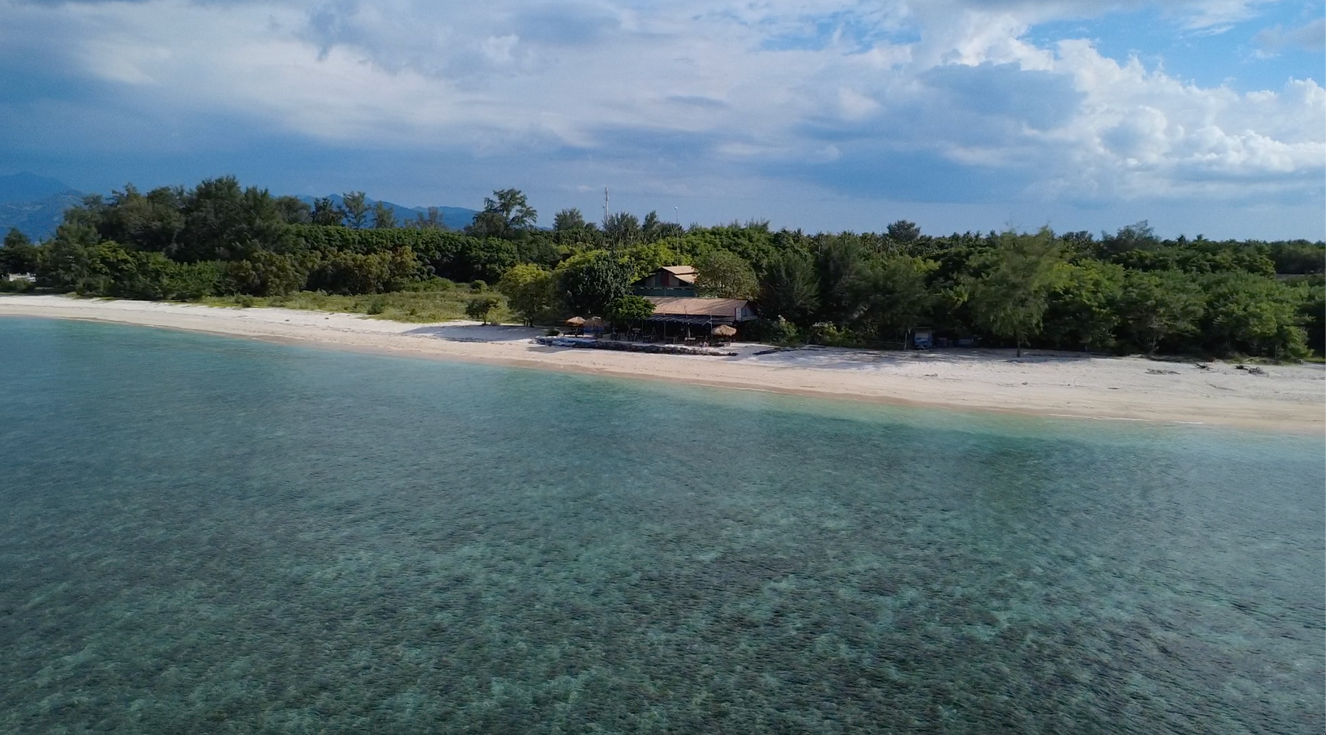 Aerial view of Gili Meno island with turquoise water and palm trees