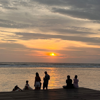 Couples watching the sunset from a pier on the Gili Islands, Lombok