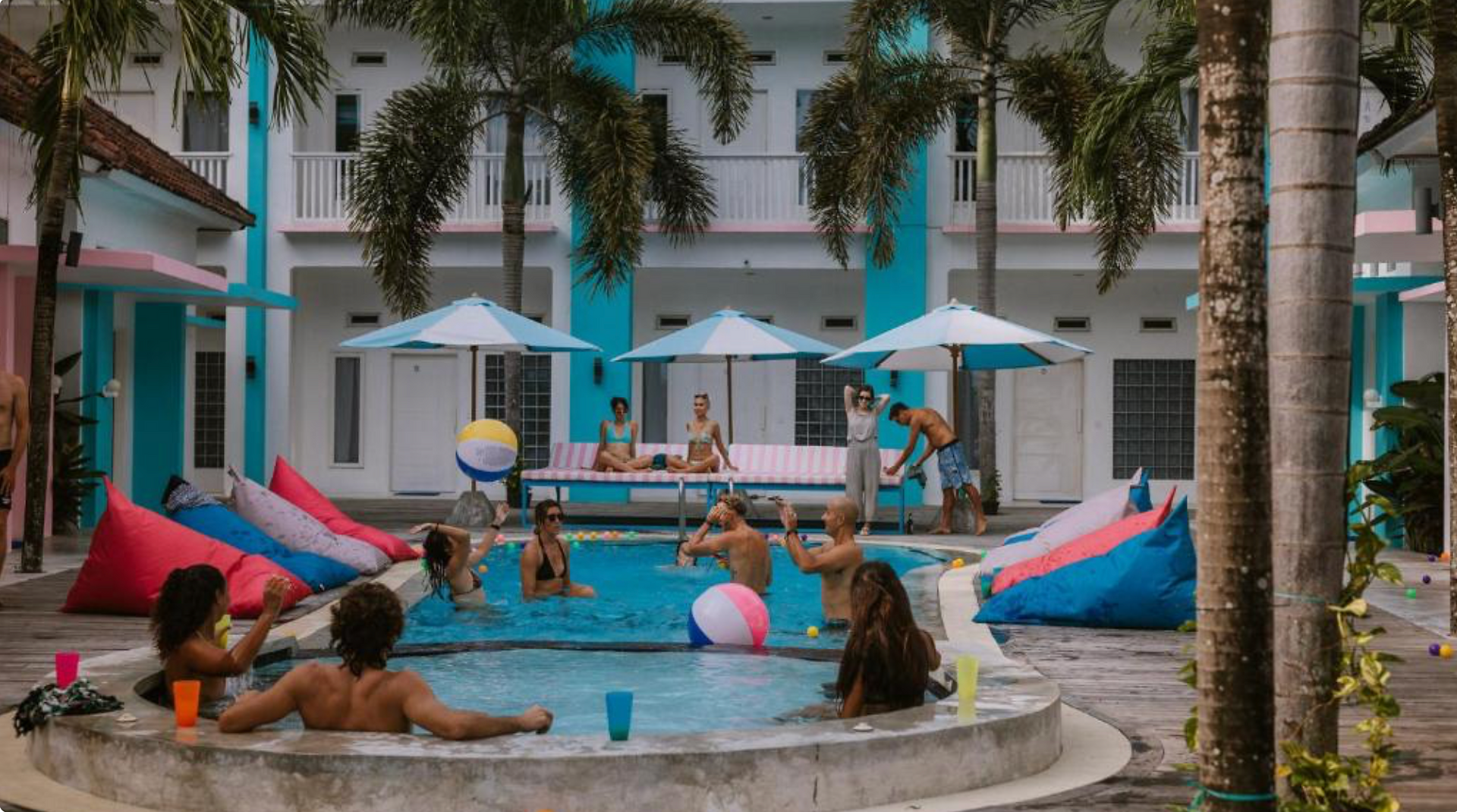 Social pool area at Mad Monkey hostel in Kuta Lombok with travellers enjoying the atmosphere