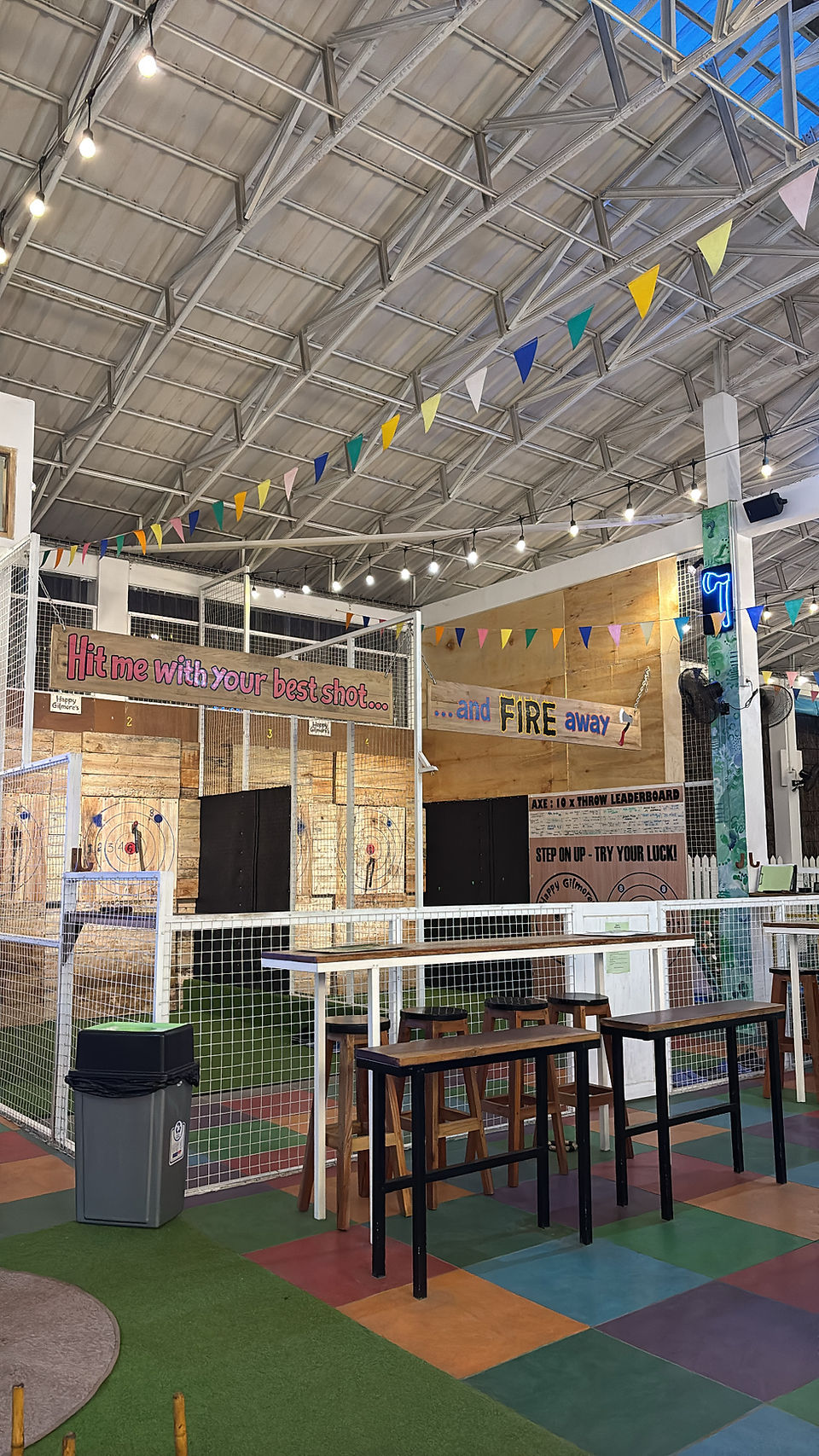 Indoor entertainment area at Happy Gilmore's Gili Air with games, lighting, and bar seating
