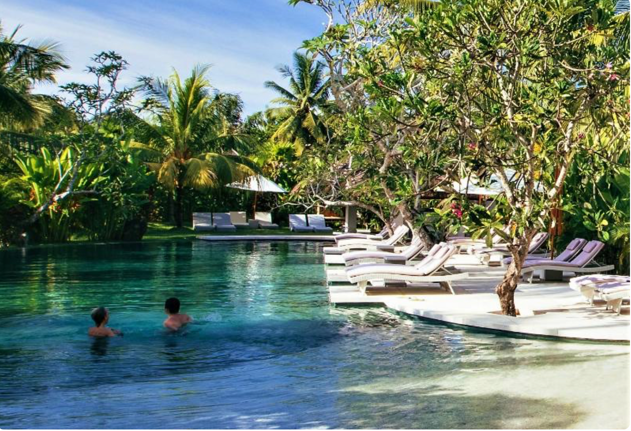Tropical swimming pool surrounded by gardens at Jivana Resort in Kuta Lombok