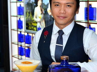 Osmund Bernard "The Hokage" posing behind a bar with a cocktail shaker.