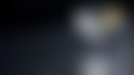 Vodka Martini in a frosted coupe glass with a lemon twist garnish on a dark minimalist bar surface