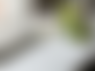 A classic Pisco Sour cocktail served in a chilled coupe glass, featuring a thick, frothy white foam head topped with three decorative drops of Angostura bitters in a heart pattern.