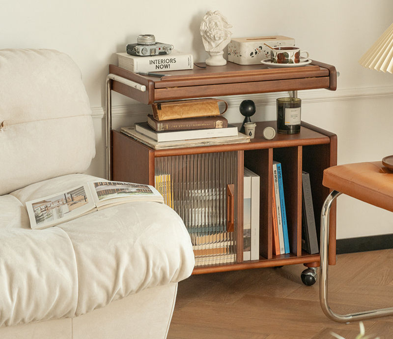 Thumbnail: Kaspar Media Trolley in walnut finish styled in a living room beside a cream sofa, with books, a bust ornament and a table la