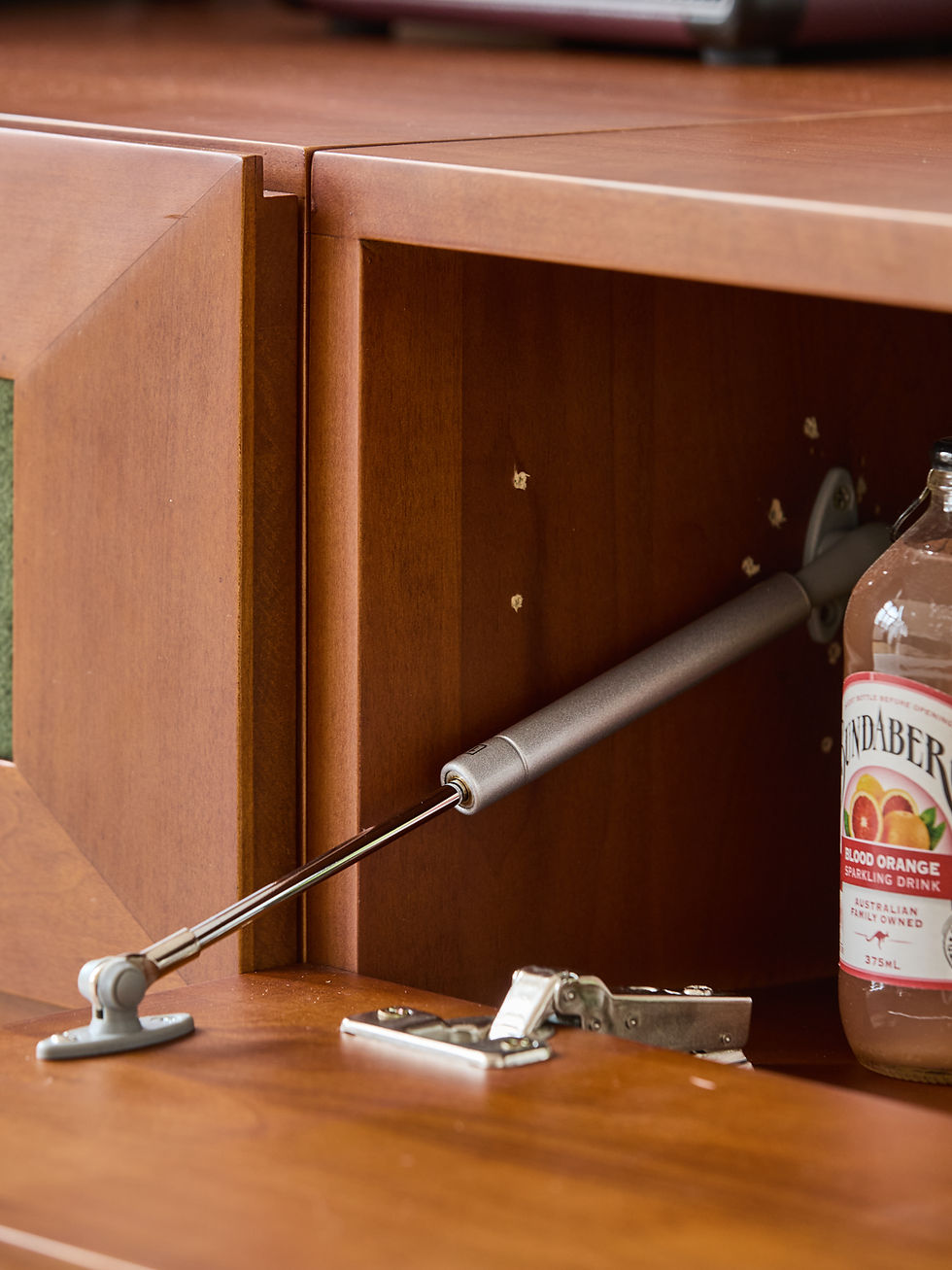 Thumbnail: Kubrick Modular Cabinet – close‑up of hydraulic soft‑close hinge inside flip‑down door module