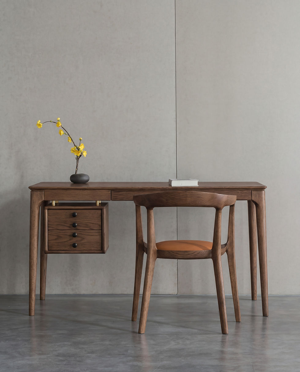 Adeline Desk in Walnut styled with a wooden armchair, flowering branch and book