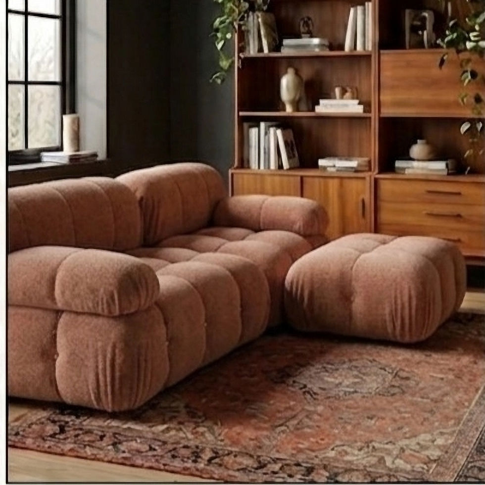 Close-up of a rust-colored modular bubble sofa with ottoman and a curved wooden coffee table on a shaggy rug in a brick loft.