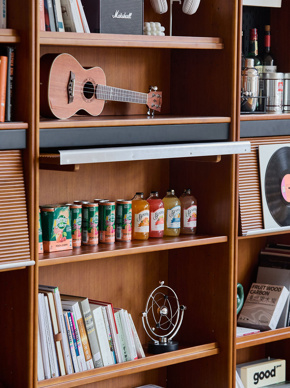 Thumbnail: Nordholm Wall Library – close-up of lower shelves holding books, vinyl and small display items
